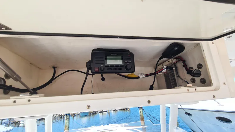 Slide: The Image of 2005 Marlago FS35 boat radio compartment with electronic equipment and wiring. - 18