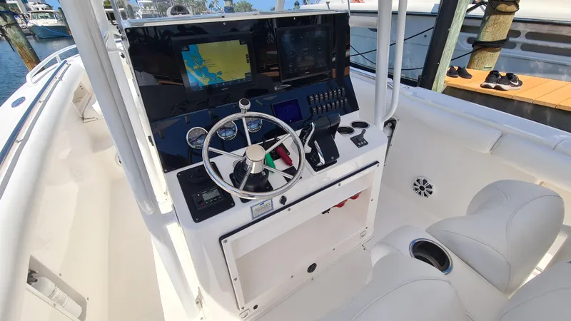 Slide: The Image of 2005 Marlago FS35 boat cockpit with steering wheel and navigation equipment. - 19