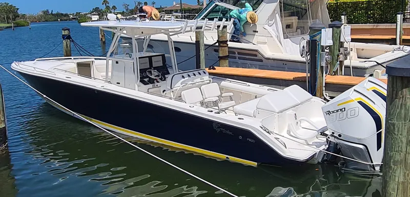 Slide: The Image of 2005 Marlago FS35 boat docked in marina, featuring sleek design and powerful engines. - 2