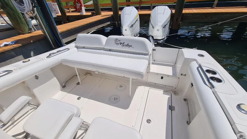 Slide: The Image of 2005 Marlago FS35 boat interior with white seating and dual outboard motors. - 22