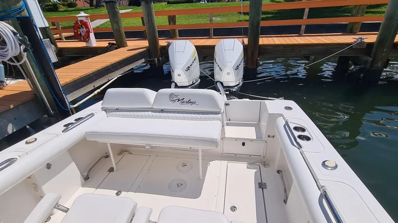 Slide: The Image of 2005 Marlago FS35 boat with twin engines docked at a marina. - 23