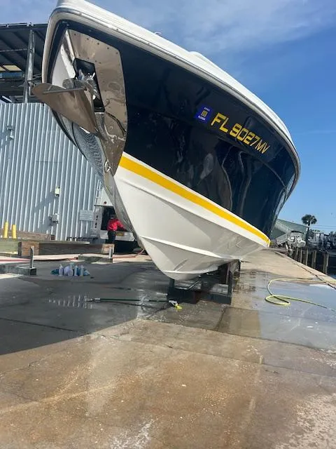 Slide: The Image of 2005 Marlago FS35 boat on dock, blue and white hull, yellow stripe, sunny day. - 27