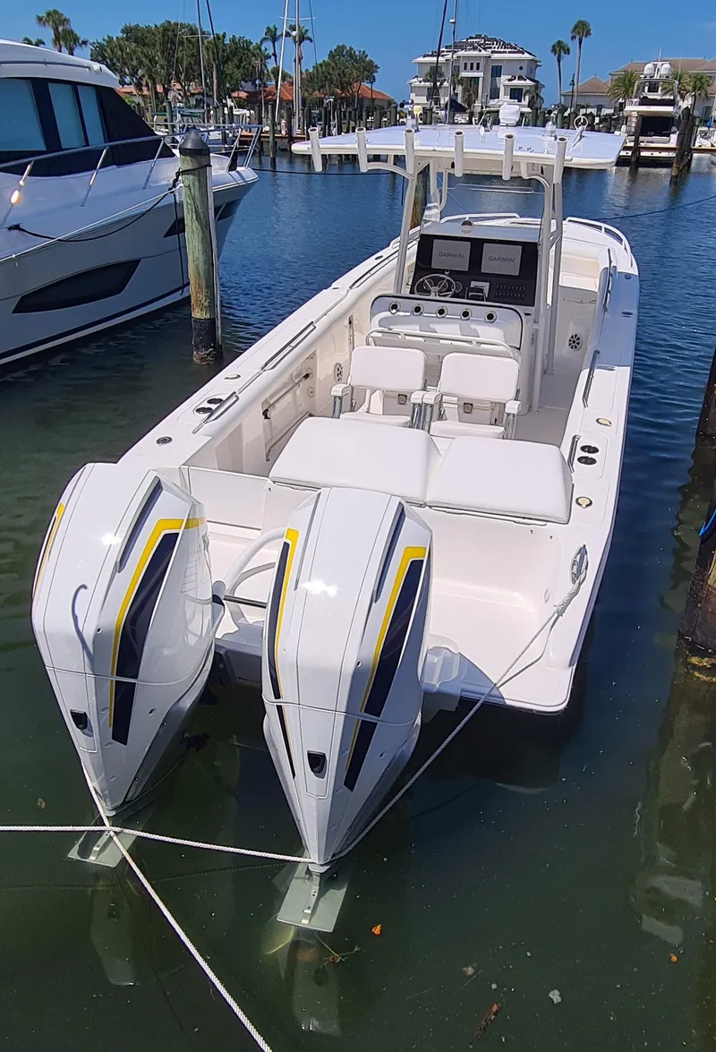 Slide: The Image of 2005 Marlago FS35 boat docked with dual outboard engines in a marina setting. - 4
