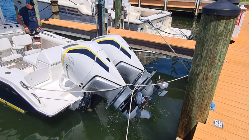 Slide: The Image of 2005 Marlago FS35 boat with twin outboard motors docked at a marina. - 5
