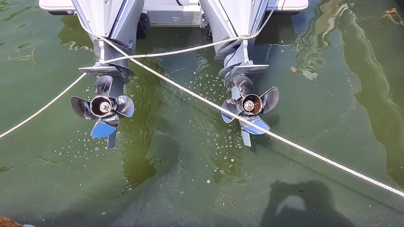 Slide: The Image of Twin outboard motors of a 2005 Marlago FS35 boat in water, with visible propellers. - 6