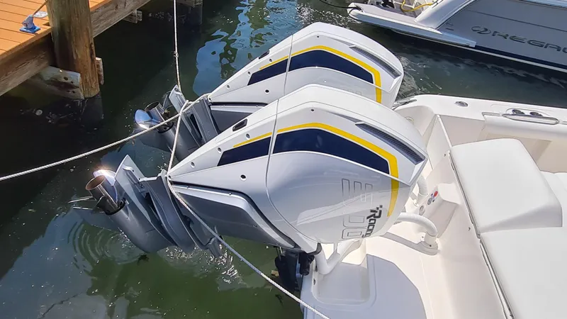 Slide: The Image of Twin outboard motors on a 2005 Marlago FS35 boat docked in water. - 7