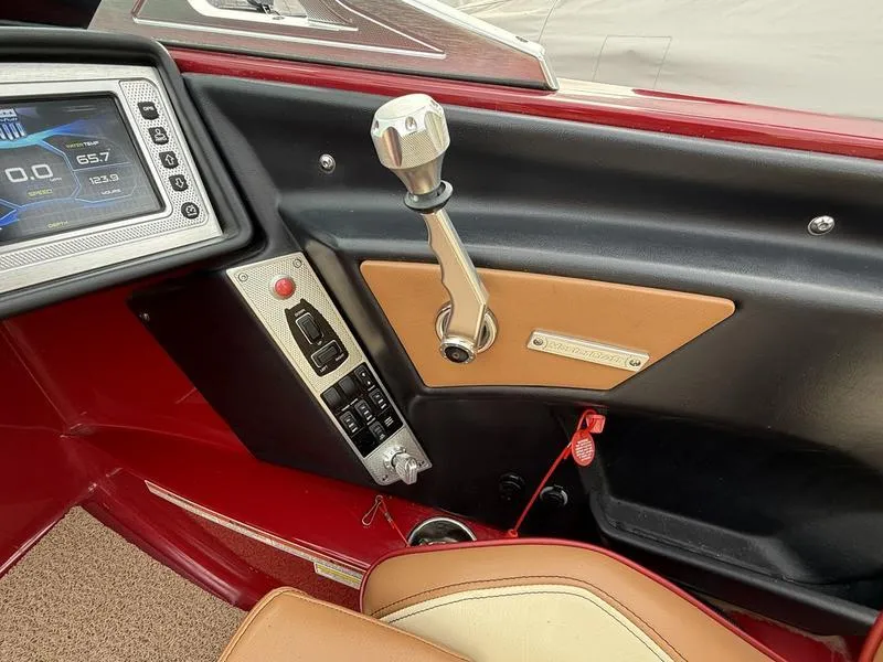 Slide: The Image of 2016 MasterCraft X23 boat dashboard with control panel and gear lever. - 10