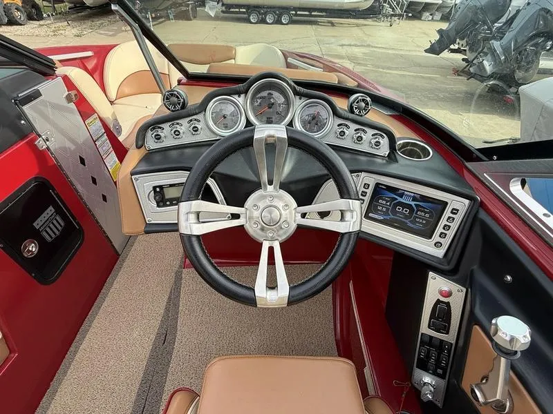 Slide: The Image of Interior dashboard of a 2016 MasterCraft X23 boat with steering wheel and control panel. - 11