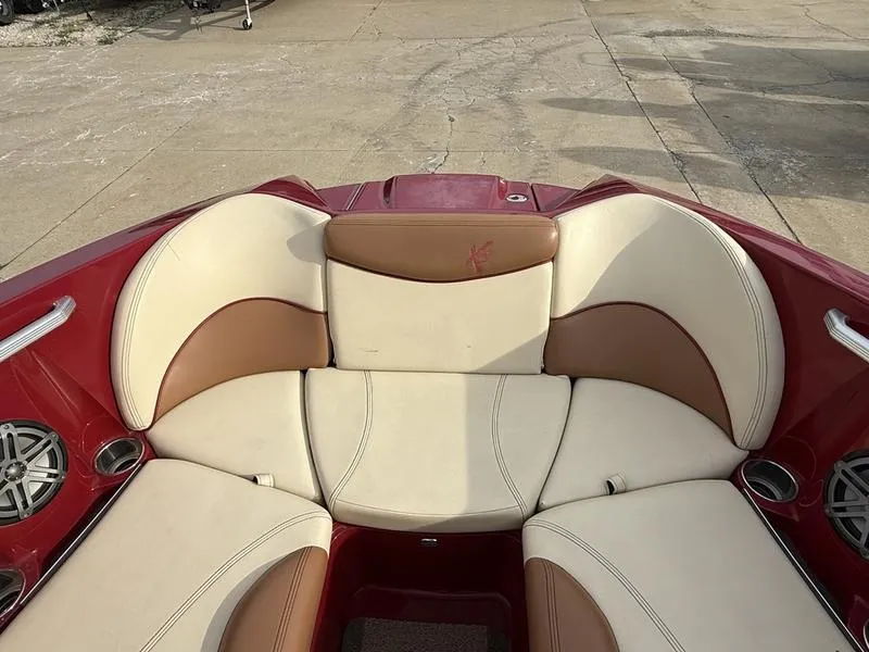 Slide: The Image of 2016 MasterCraft X23 boat interior with red and beige seating. - 15