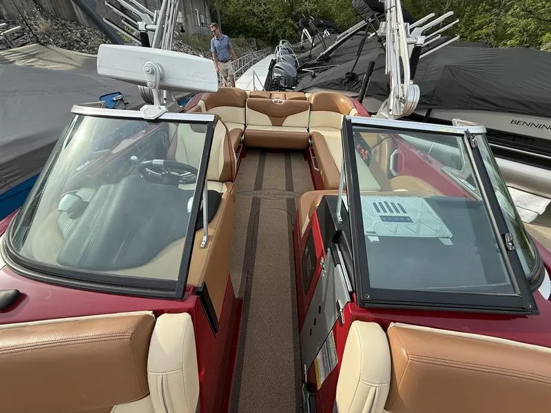 Slide: The Image of 2016 MasterCraft X23 boat interior with tan seating and open windshield. - 16