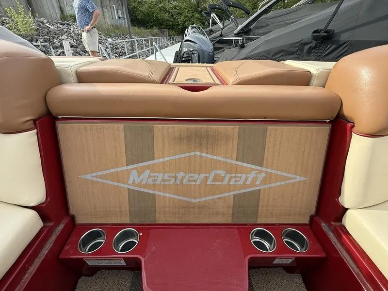 Slide: The Image of 2016 MasterCraft X23 boat interior with logo and cup holders. - 21