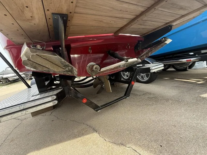 Slide: The Image of 2016 MasterCraft X23 boat underside showing propeller and rudder on trailer. - 25