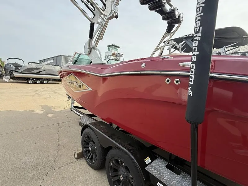 Slide: The Image of 2016 MasterCraft X23 boat in red on a trailer, side view. - 3