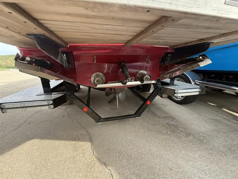 Slide: The Image of 2016 MasterCraft X23 boat underside showing propeller and trailer. - 8