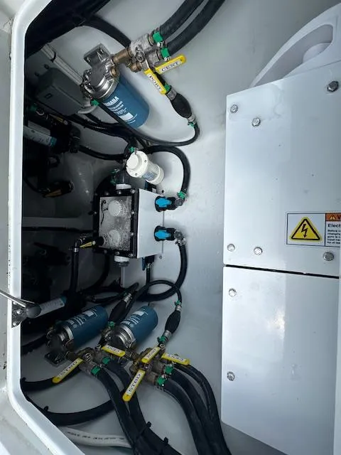 Slide: The Image of 2024 Contender 39 ST engine compartment with fuel filters and electrical components. - 12