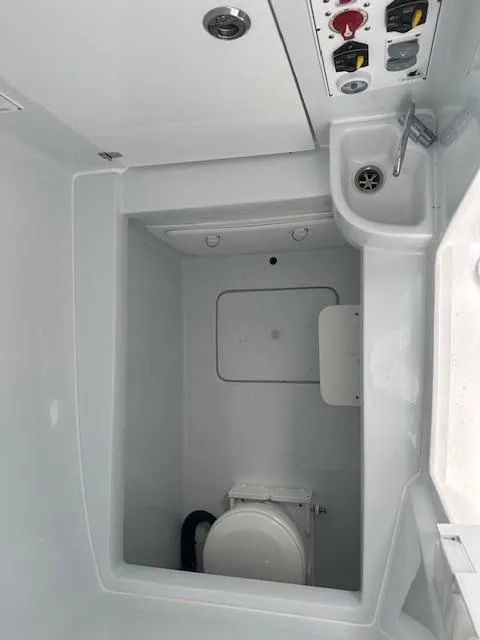 Slide: The Image of 2024 Contender 39 ST boat bathroom with sink and toilet. - 13