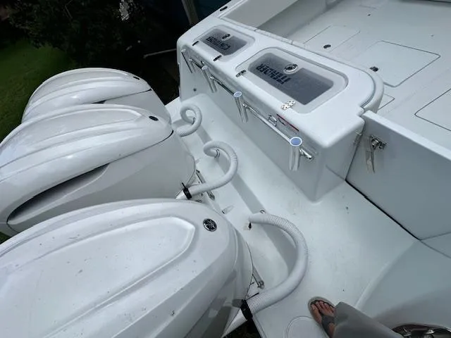 Slide: The Image of 2024 Contender 39 ST boat with triple outboard engines and deck storage compartments. - 17