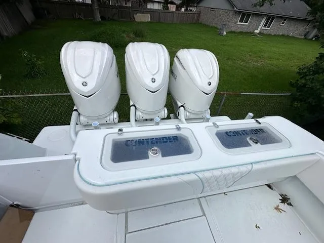 Slide: The Image of 2024 Contender 39 ST boat with triple outboard engines and dual livewells. - 4