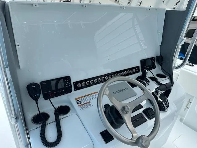 Slide: The Image of 2024 Contender 39 ST boat dashboard with Garmin navigation and control systems. - 8