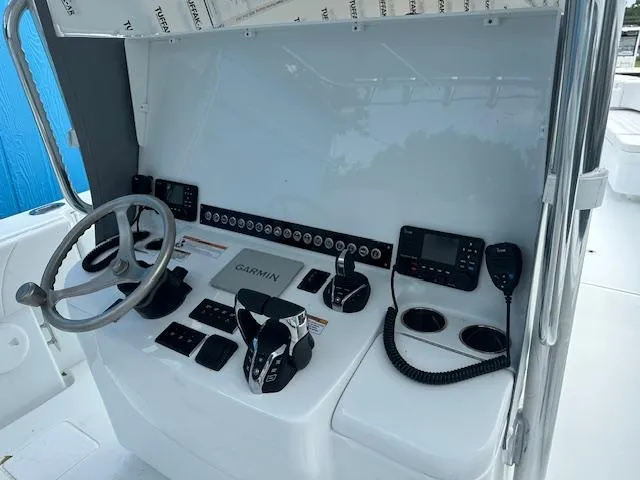 Slide: The Image of 2024 Contender 39 ST boat dashboard with Garmin navigation and control systems. - 9