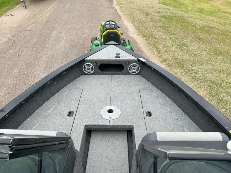 Slide: The Image of 2022 Lowe Fish & Ski 19 boat deck with speakers, parked on a grassy area. - 5