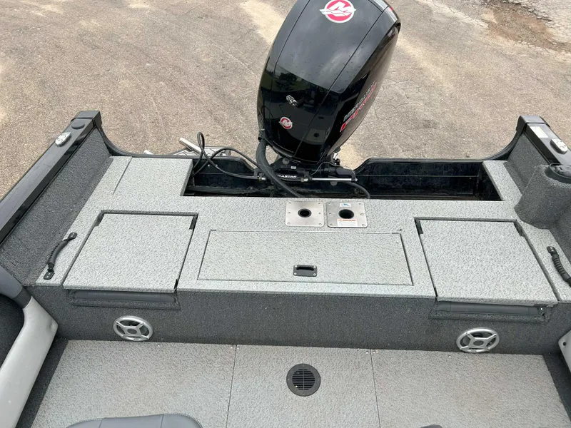 Slide: The Image of 2022 Lowe Fish & Ski 19 boat interior with motor, storage compartments, and speakers. - 7