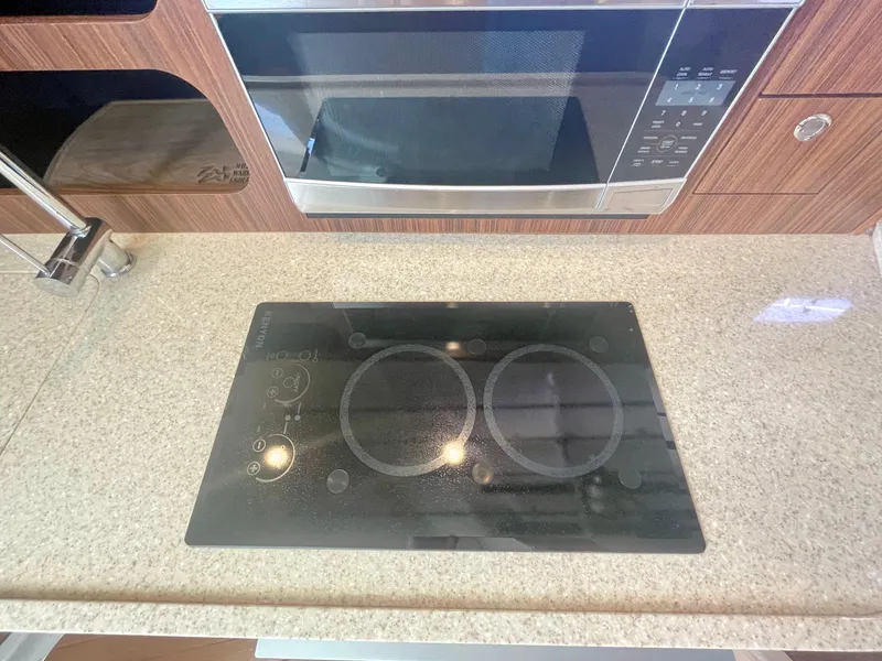 Slide: The Image of Stovetop and microwave in 2015 Pursuit 345 Offshore boat kitchen. - 21