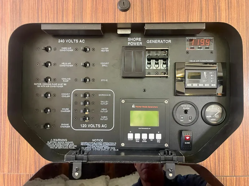 Slide: The Image of Electrical control panel of a 2015 Pursuit 345 Offshore boat, featuring shore power and generator switches. - 26