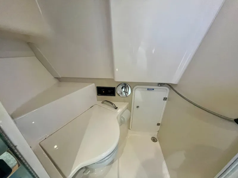 Slide: The Image of 2015 Pursuit 345 Offshore boat bathroom with toilet and shower area. - 33