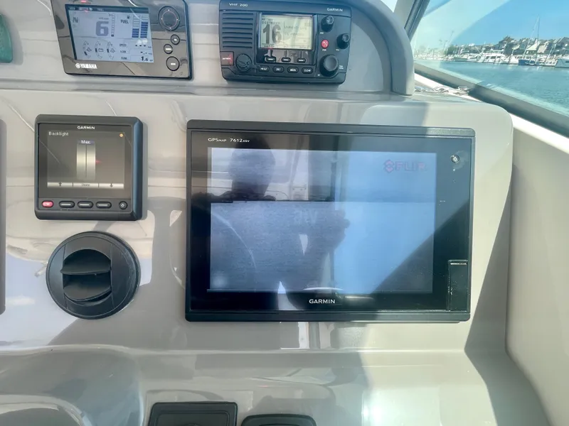 Slide: The Image of Control panel of a 2015 Pursuit 345 Offshore boat with Garmin displays. - 39