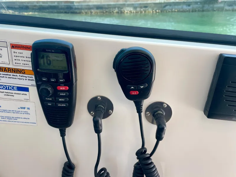 Slide: The Image of VHF radio and microphone on 2015 Pursuit 345 Offshore boat dashboard. - 40