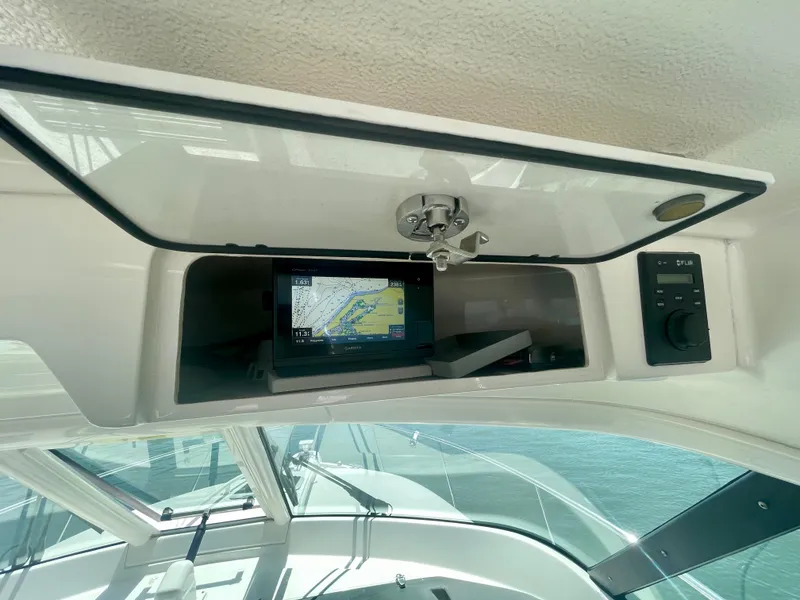 Slide: The Image of 2015 Pursuit 345 Offshore boat dashboard with navigation system and controls. - 41