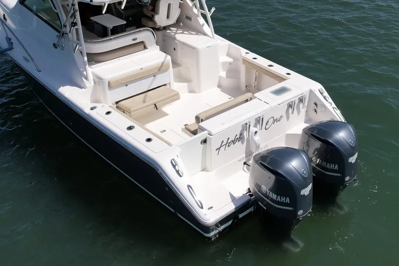 Slide: The Image of 2015 Pursuit 345 Offshore boat with twin Yamaha engines on water. - 7