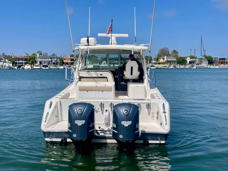 Slide: The Image of 2015 Pursuit 345 Offshore boat with dual Yamaha engines on calm water. - 9