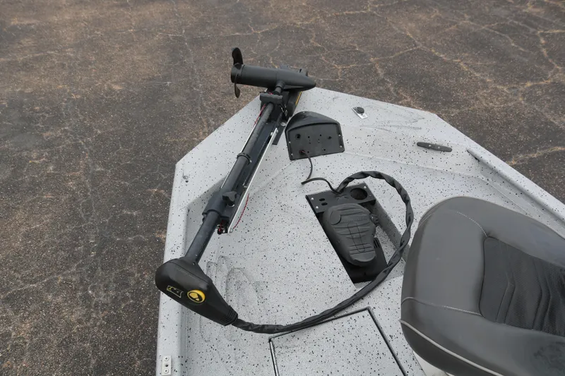 Slide: The Image of 2016 Xpress XP7 boat with trolling motor and seating on a speckled deck. - 10