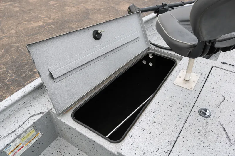 Slide: The Image of 2016 Xpress XP7 boat storage compartment with open lid and adjacent seat. - 13