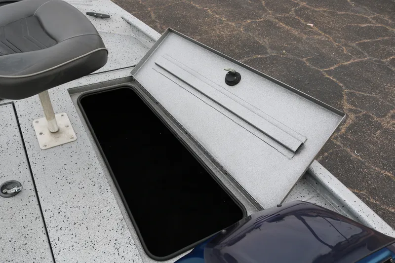Slide: The Image of 2016 Xpress XP7 boat storage compartment with open lid and adjacent seat. - 15