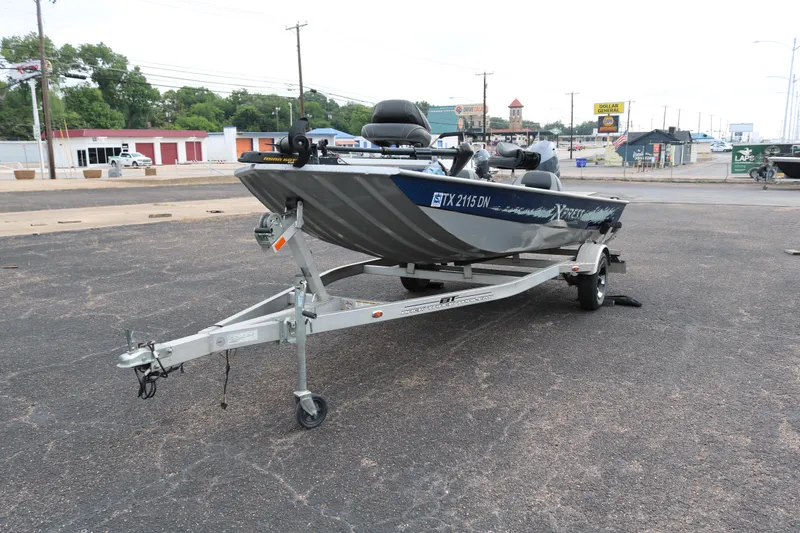 Slide: The Image of 2016 Xpress XP7 boat on trailer in parking lot. - 2