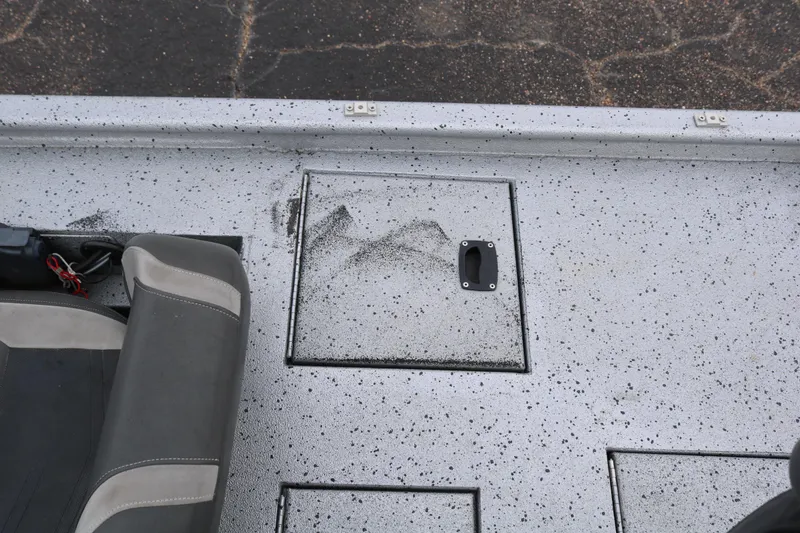 Slide: The Image of 2016 Xpress XP7 boat interior with speckled flooring and storage compartment. - 21