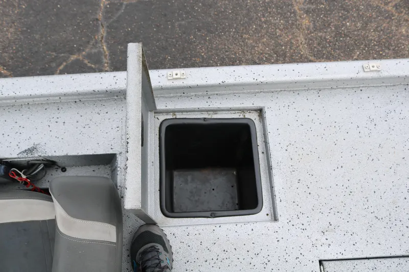 Slide: The Image of 2016 Xpress XP7 boat storage compartment with open lid, showing interior space. - 22