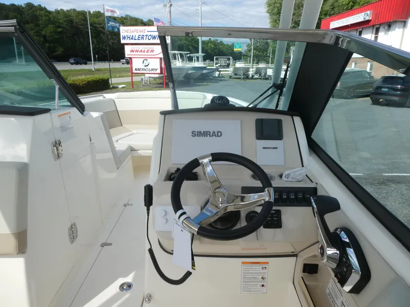 Slide: The Image of 2025 Boston Whaler 240 Vantage boat helm with Simrad navigation system. - 11