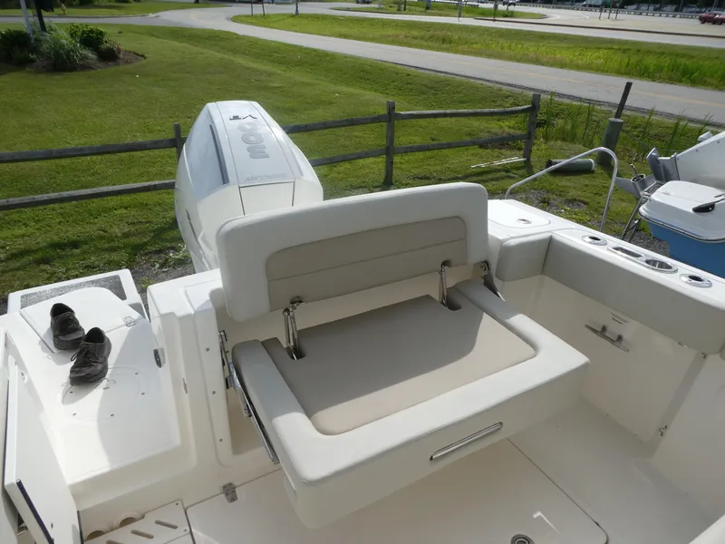 Slide: The Image of 2025 Boston Whaler 240 Vantage boat interior with seating and outboard motor. - 7
