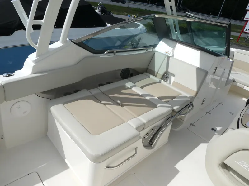 Slide: The Image of 2025 Boston Whaler 240 Vantage boat interior with cushioned seating and sleek design. - 8