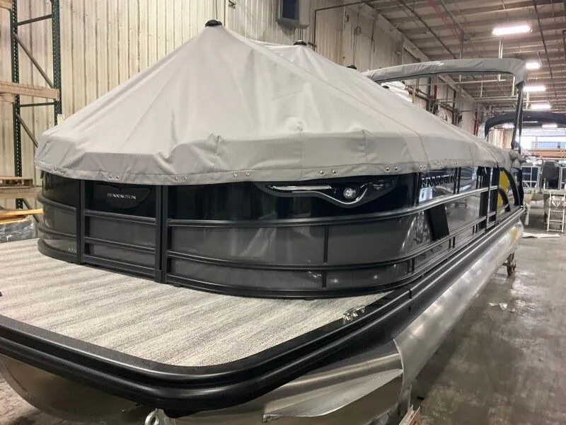 Slide: The Image of 2025 Bennington 26 MSB pontoon boat with cover in a warehouse setting. - 12