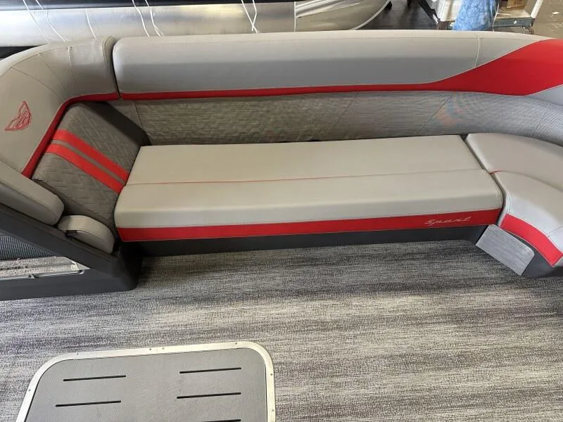 Slide: The Image of 2025 Bennington 26 MSB boat interior with gray and red seating on a textured floor. - 8