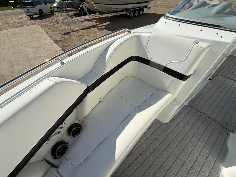Slide: The Image of 2009 Formula 240 Bowrider interior with white seating and cup holders, parked on a trailer. - 11