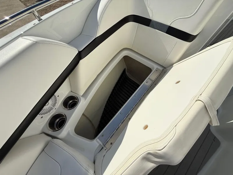 Slide: The Image of 2009 Formula 240 Bowrider interior with open storage compartment and cup holders. - 12