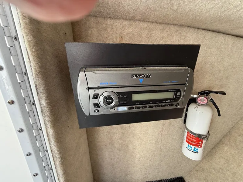 Slide: The Image of Kenwood stereo system and fire extinguisher in 2009 Formula 240 Bowrider boat interior. - 15