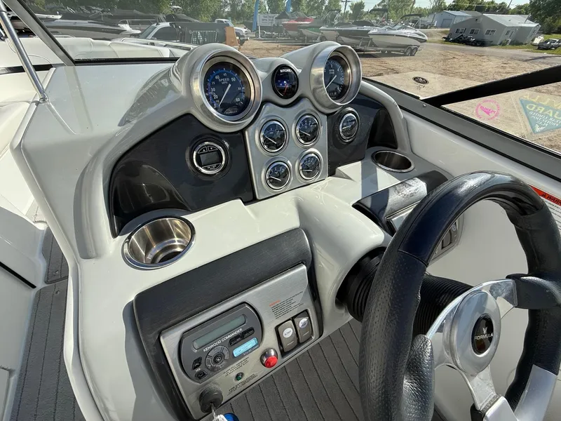 Slide: The Image of Dashboard of a 2009 Formula 240 Bowrider boat with gauges and steering wheel. - 17