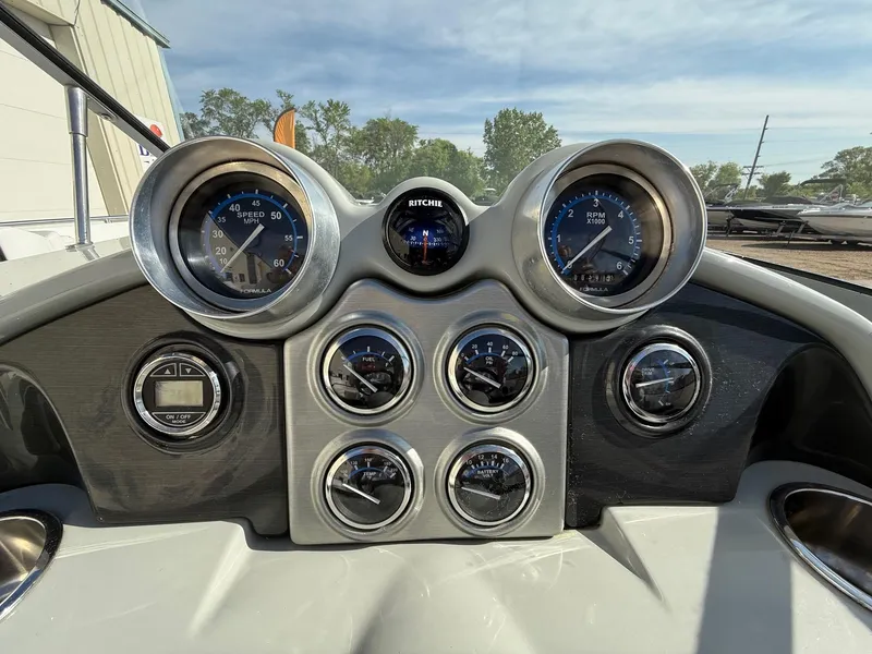 Slide: The Image of Dashboard of a 2009 Formula 240 Bowrider boat with gauges and controls. - 19